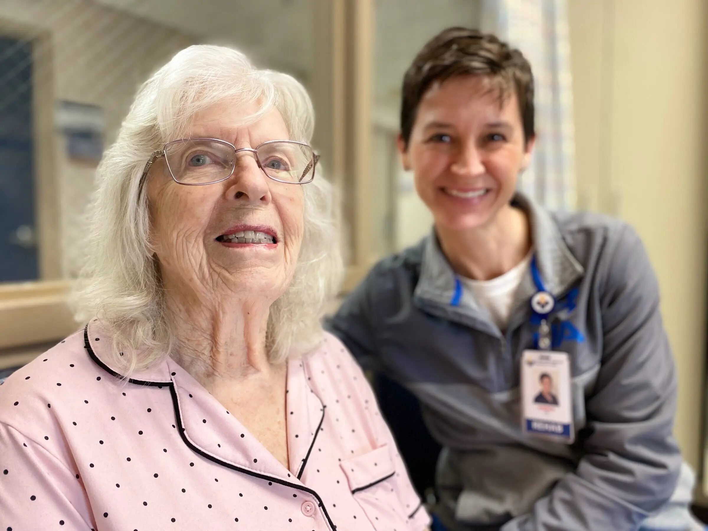 A smiling patient and her therapist, cheek to cheek, in CRMC's swing bed program