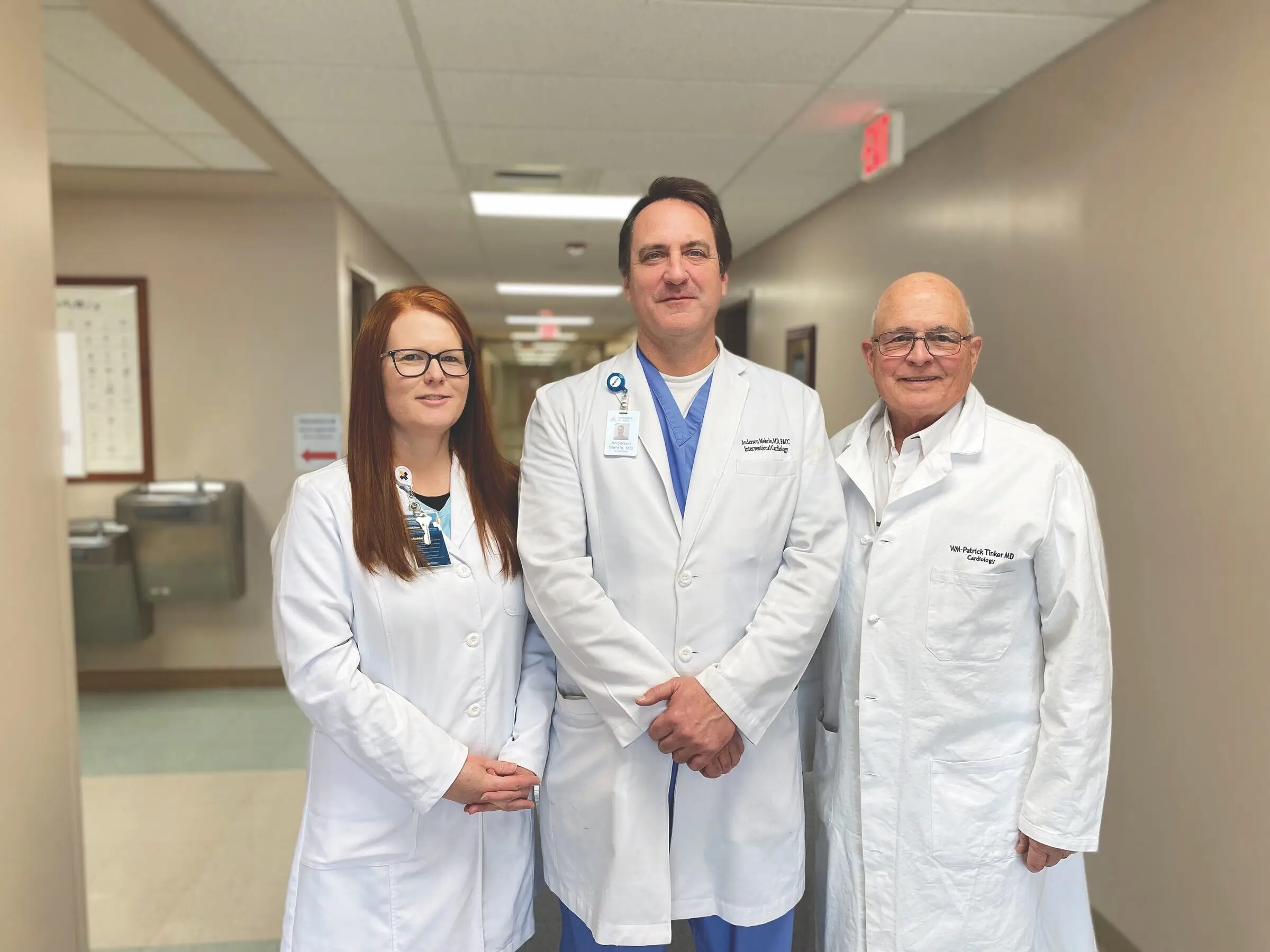 Three CRMC cardiology providers in white coats in a hospital corridor